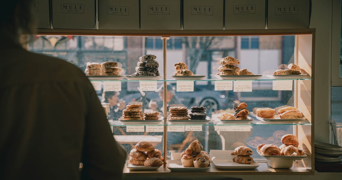 Cozy bakery display case filled with freshly baked pastries and artisanal breads
