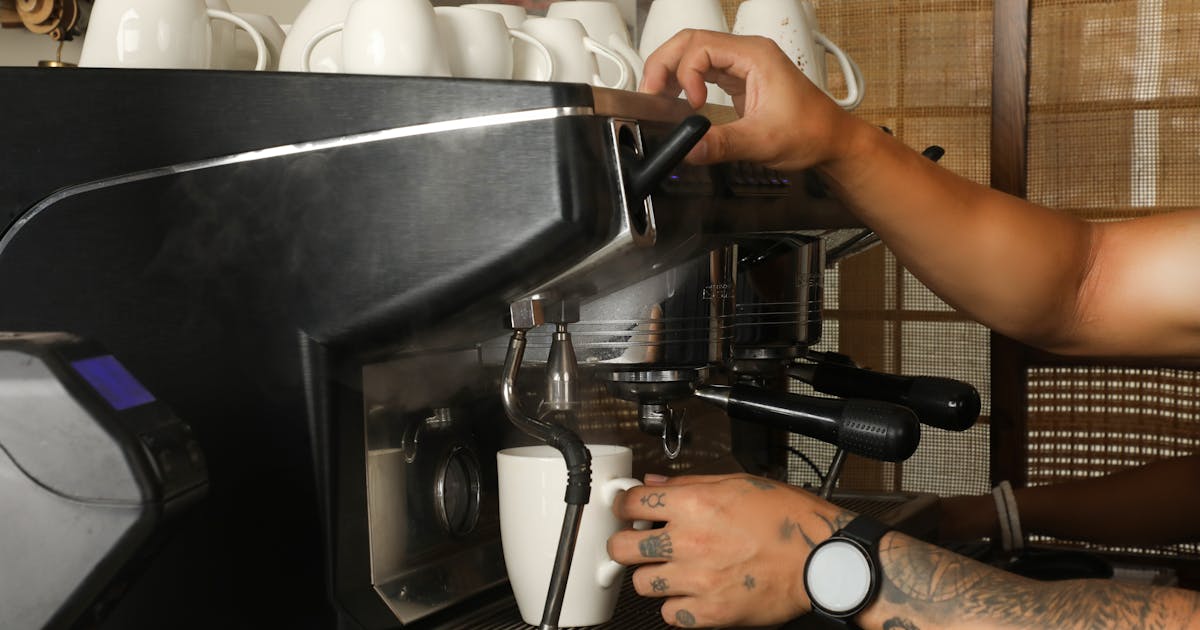 Barista pulling an espresso shot on a modern machine in a specialty café in Bengaluru, India