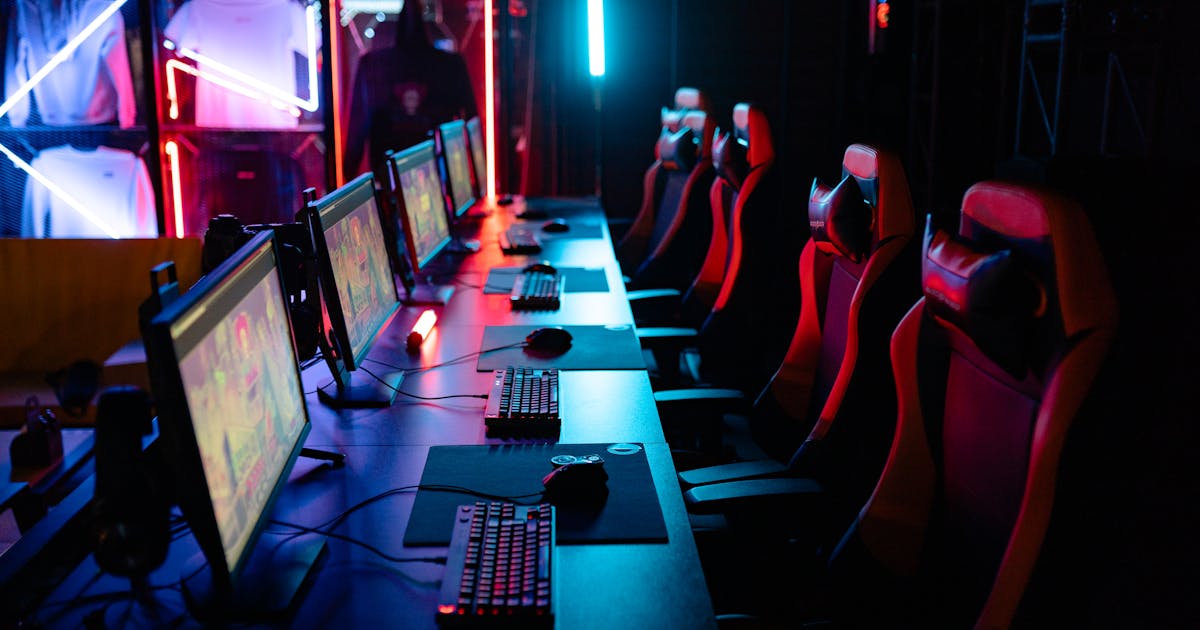 Premium esports gaming lounge with multiple high-spec PCs, RGB lighting, and gaming chairs
