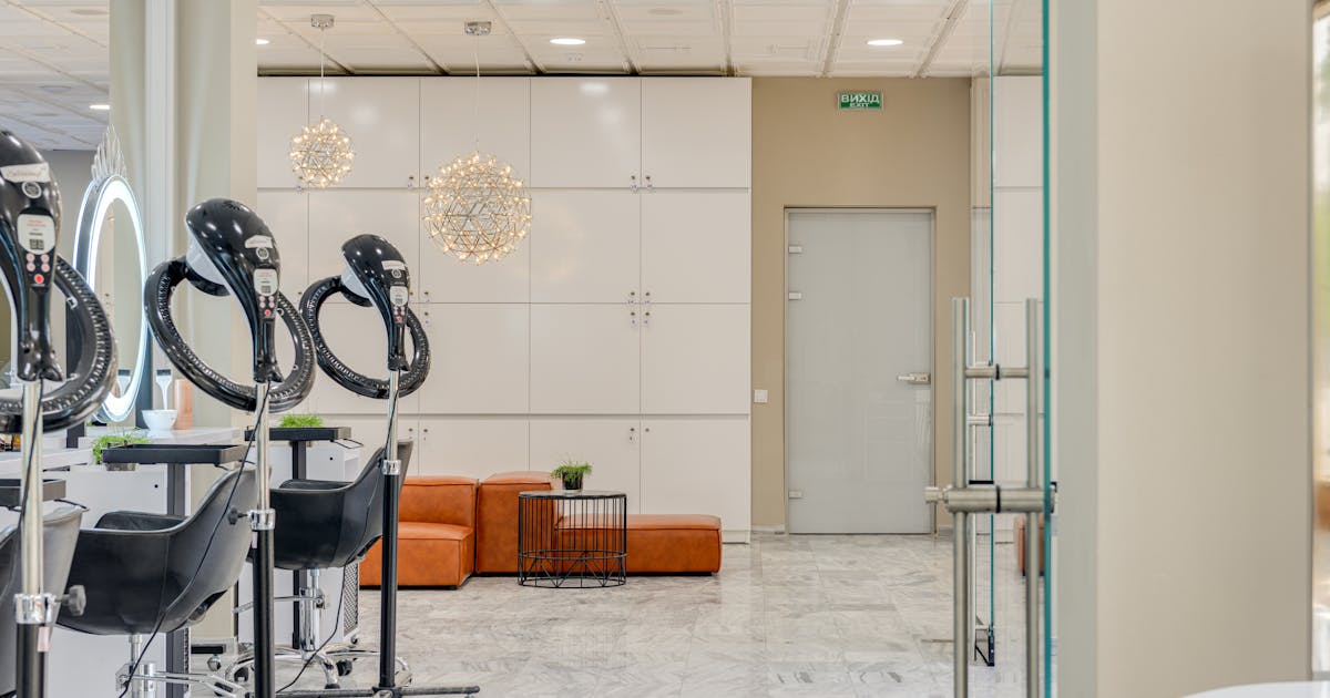 Premium hair salon interior with sleek styling chairs, mirrors, and marble flooring